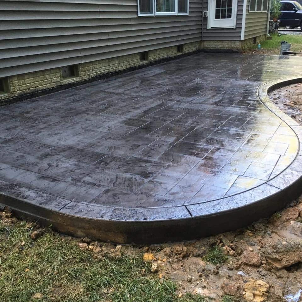A stamped concrete patio with outdoor living space. 