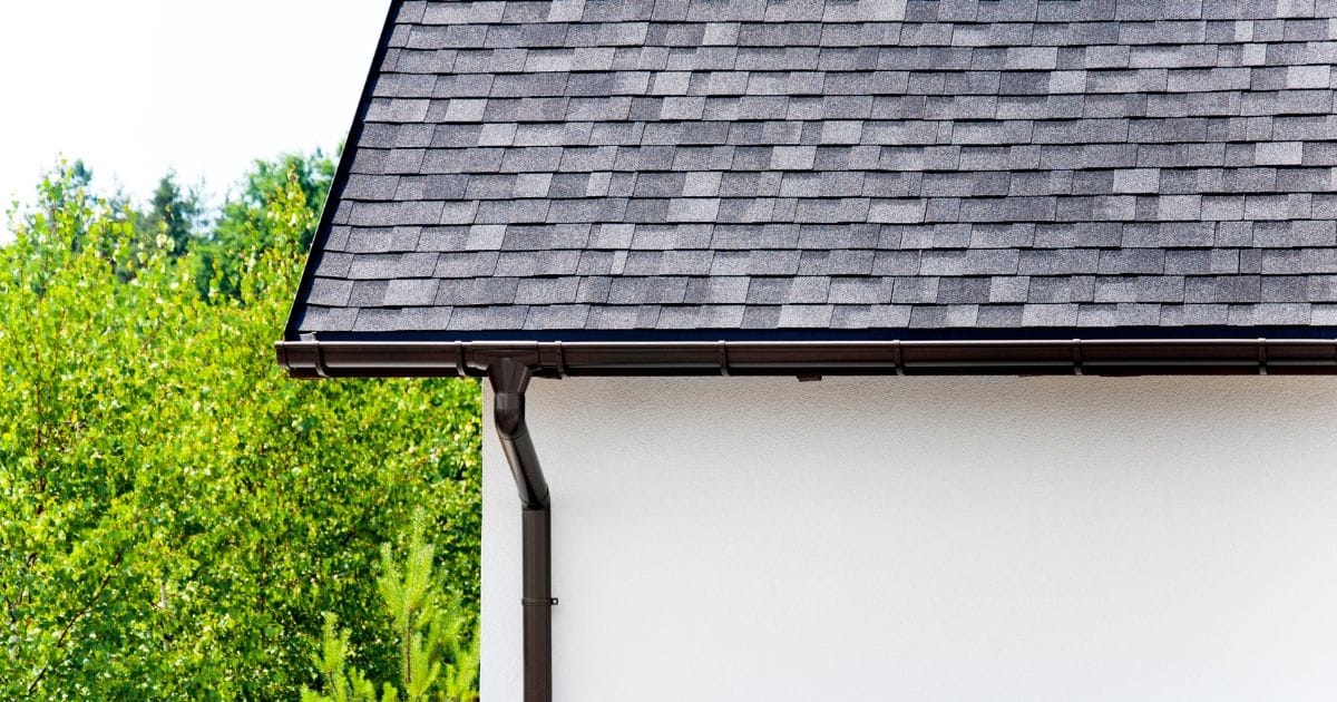 Grey shingled roof that has been recently replaced on a white home