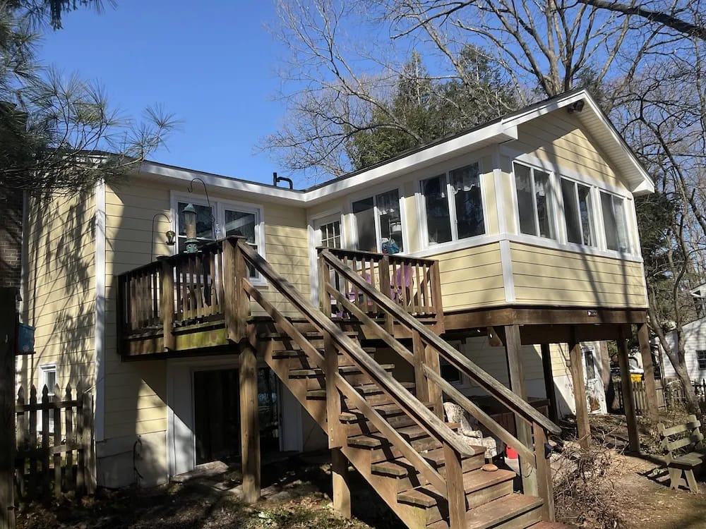 A detached shed with a green standing seam metal roof. 