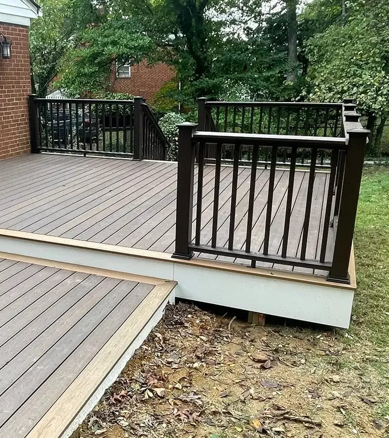 A detached shed with a green standing seam metal roof. 
