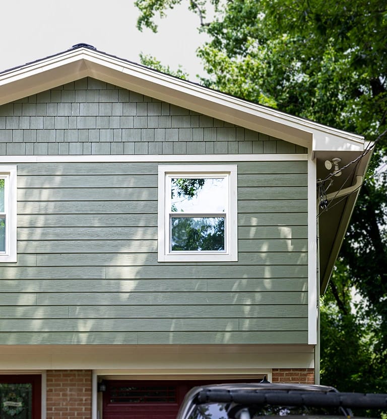 James Hardie rough shake with white trim.